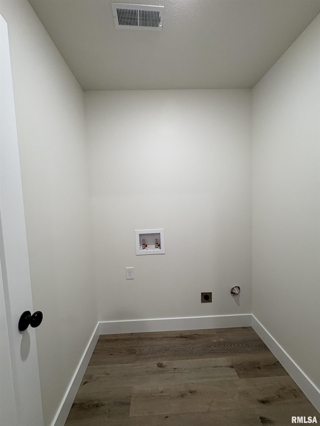 209 Madison St, Cambria, IL 62915 - laundry area featuring electric dryer hookup, washer hookup, wood finished floors, and baseboards