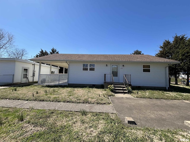 view of front of house featuring a carport and roof with shingles