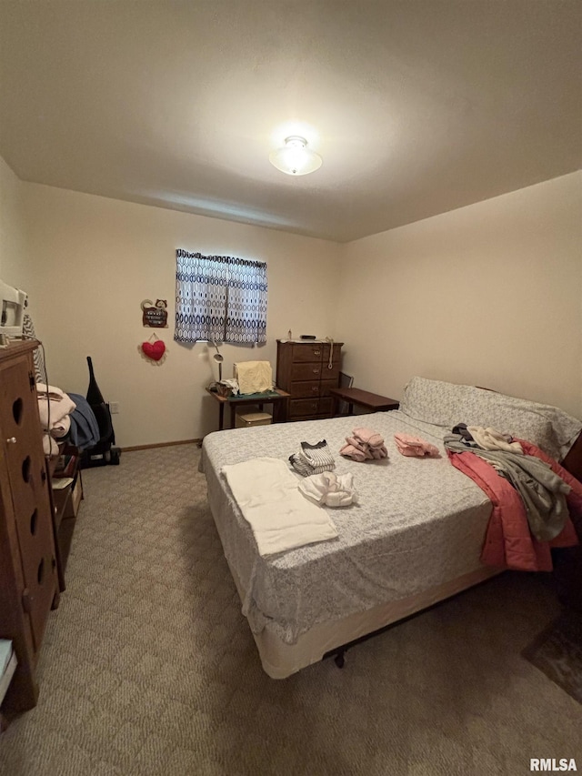 bedroom with carpet flooring and baseboards