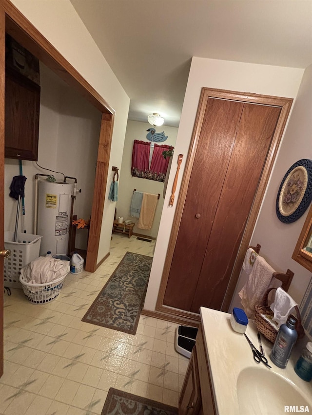 bathroom with vanity and water heater