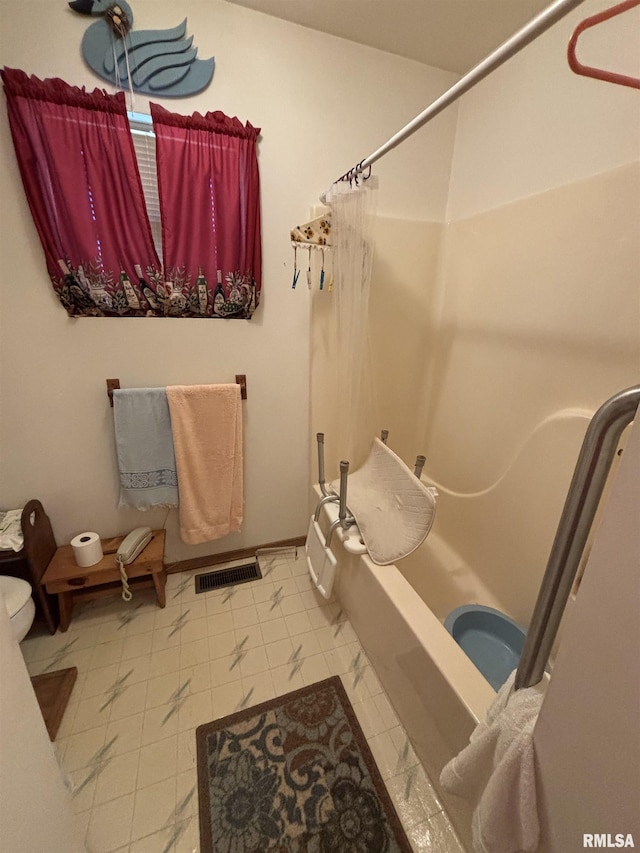 bathroom with toilet, shower / bath combo, and visible vents
