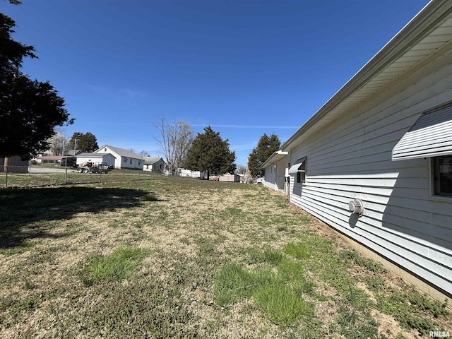 view of yard featuring fence and a residential view