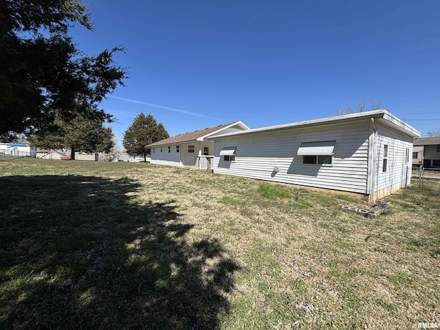 back of house with a yard and fence
