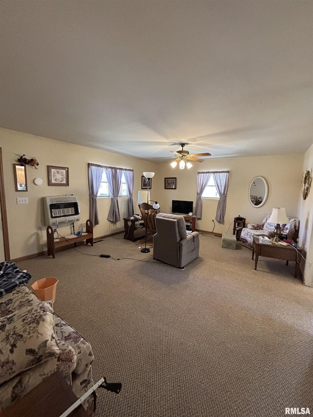 carpeted living room featuring heating unit, a ceiling fan, plenty of natural light, and baseboards
