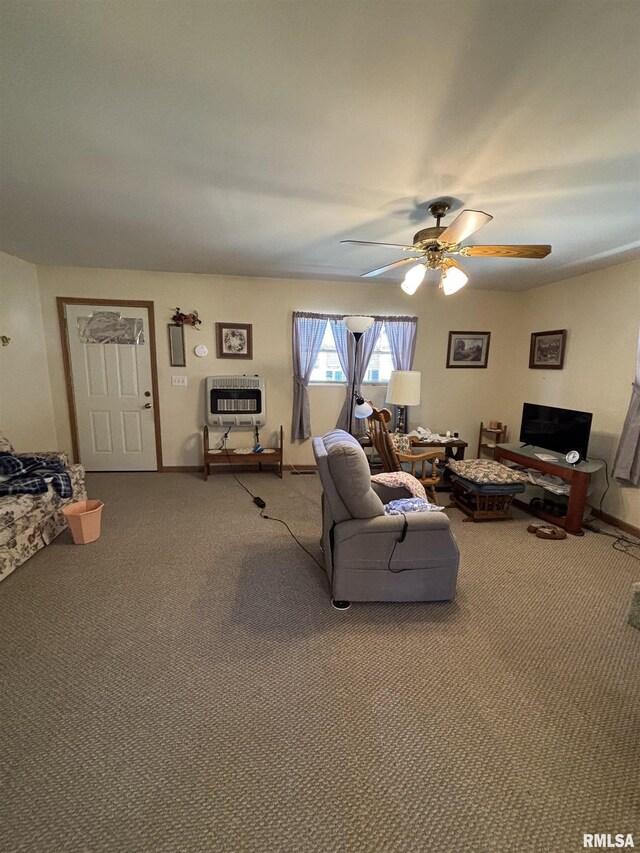 living room with baseboards, heating unit, carpet, and a ceiling fan