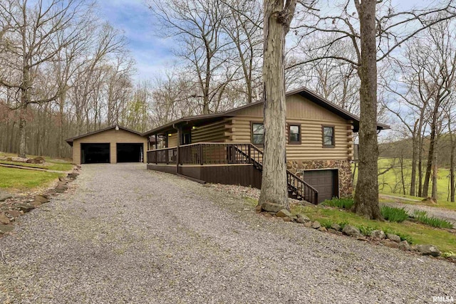 320 Nelson Ln, Grantsburg, IL 62943 - view of front of property featuring log siding, stone siding, and a garage