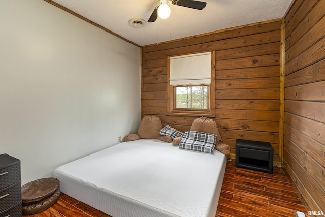 320 Nelson Ln, Grantsburg, IL 62943 - bedroom featuring wood walls, a ceiling fan, and dark wood finished floors