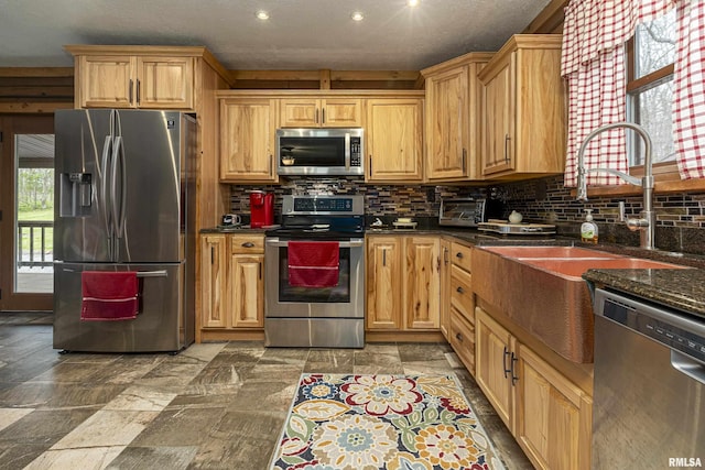 320 Nelson Ln, Grantsburg, IL 62943 - kitchen featuring stone finish flooring, a sink, tasteful backsplash, appliances with stainless steel finishes, and dark stone counters