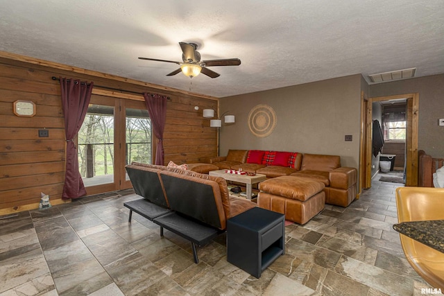 320 Nelson Ln, Grantsburg, IL 62943 - living area featuring a ceiling fan, a textured ceiling, stone finish flooring, and visible vents