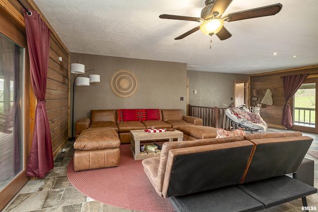 320 Nelson Ln, Grantsburg, IL 62943 - living area featuring wood walls, stone finish flooring, a textured ceiling, and ceiling fan