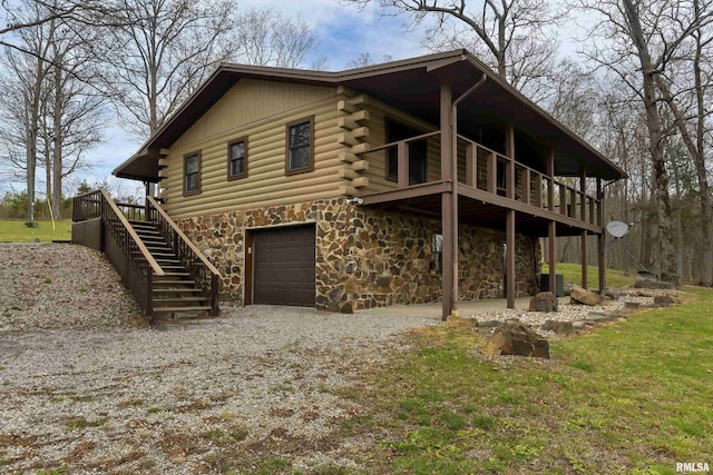 320 Nelson Ln, Grantsburg, IL 62943 - view of front of property with stairway, an attached garage, stone siding, log siding, and central AC unit