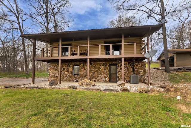 320 Nelson Ln, Grantsburg, IL 62943 - rear view of house featuring stone siding, a yard, cooling unit, and log exterior