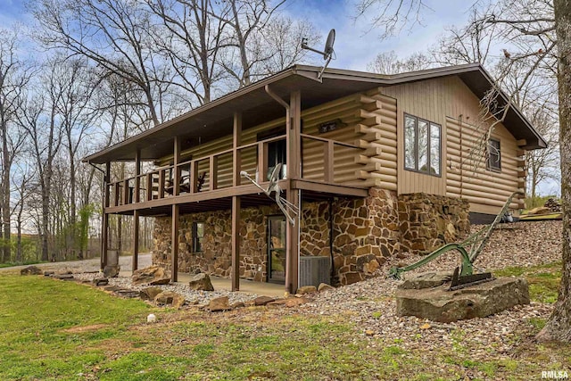 320 Nelson Ln, Grantsburg, IL 62943 - rear view of house with cooling unit, stone siding, log siding, and a patio