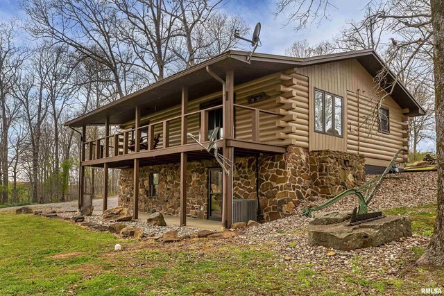 320 Nelson Ln, Grantsburg, IL 62943 - rear view of property with cooling unit, stone siding, a patio area, and log exterior
