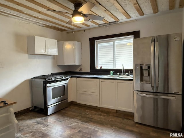 kitchen with a sink, a ceiling fan, dark wood finished floors, stainless steel appliances, and white cabinets