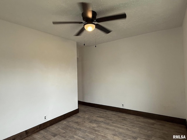 unfurnished room featuring a textured ceiling, wood finished floors, baseboards, and a ceiling fan