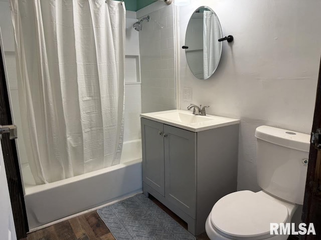 full bathroom featuring wood finished floors, toilet, vanity, and shower / bathtub combination with curtain
