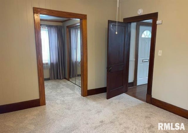 carpeted empty room with baseboards