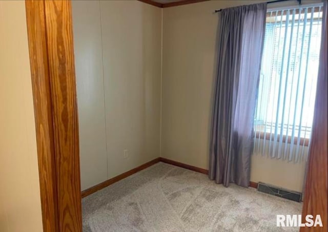 unfurnished room with light colored carpet, visible vents, and baseboards
