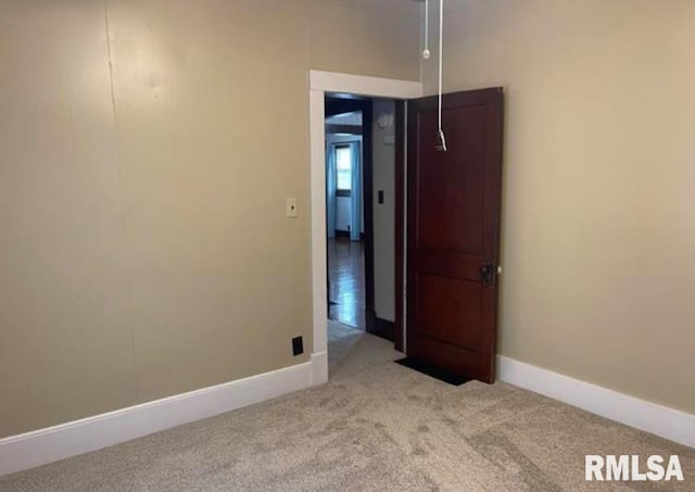 unfurnished room featuring carpet flooring and baseboards