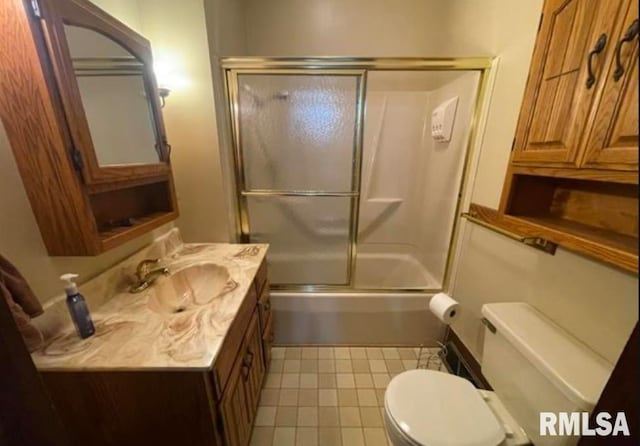 full bathroom with combined bath / shower with glass door, toilet, and vanity