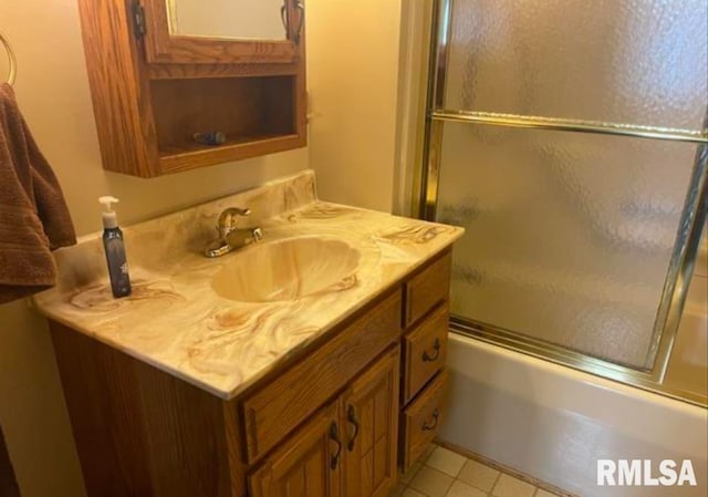 full bath featuring combined bath / shower with glass door and vanity