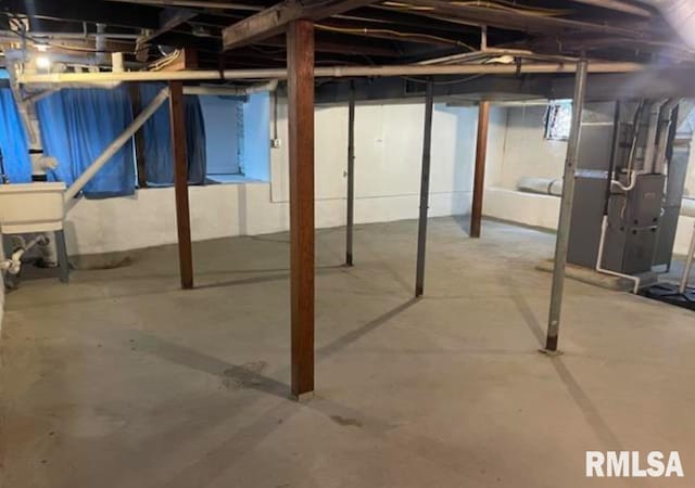 unfinished below grade area featuring heating unit