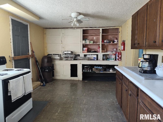 kitchen featuring light countertops, open shelves, a textured ceiling, white range with electric cooktop, and a ceiling fan