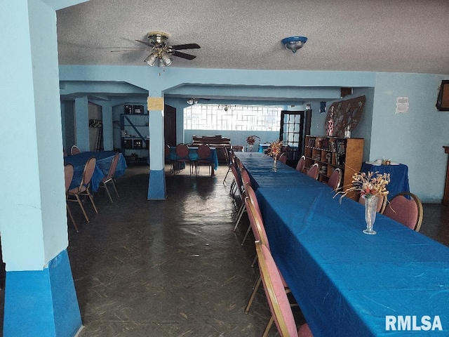 dining room with a textured ceiling and ceiling fan
