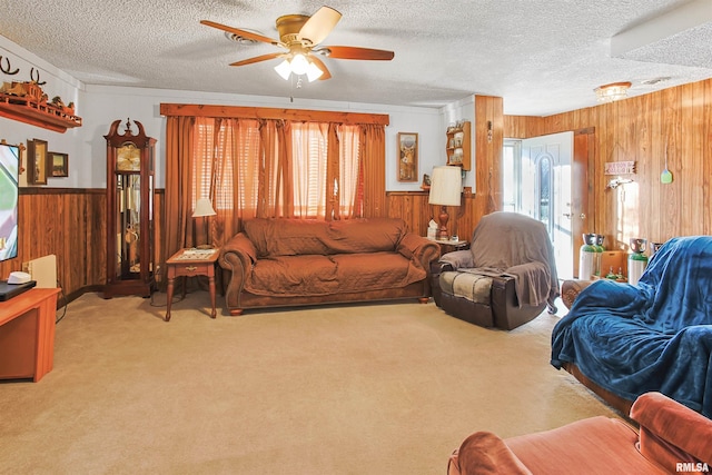 125 Central Hill Rd, Grantsburg, IL 62943 - living room featuring carpet floors, a textured ceiling, wood walls, and a ceiling fan