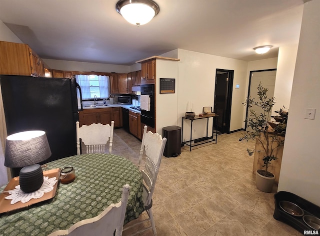 kitchen featuring a sink and black appliances