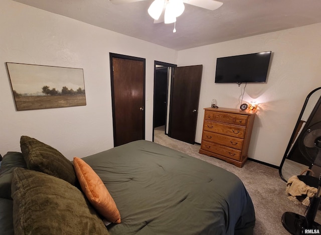 bedroom featuring light carpet, baseboards, and ceiling fan