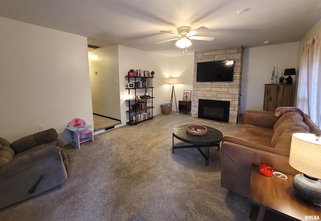 carpeted living room with a fireplace, ceiling fan, and visible vents