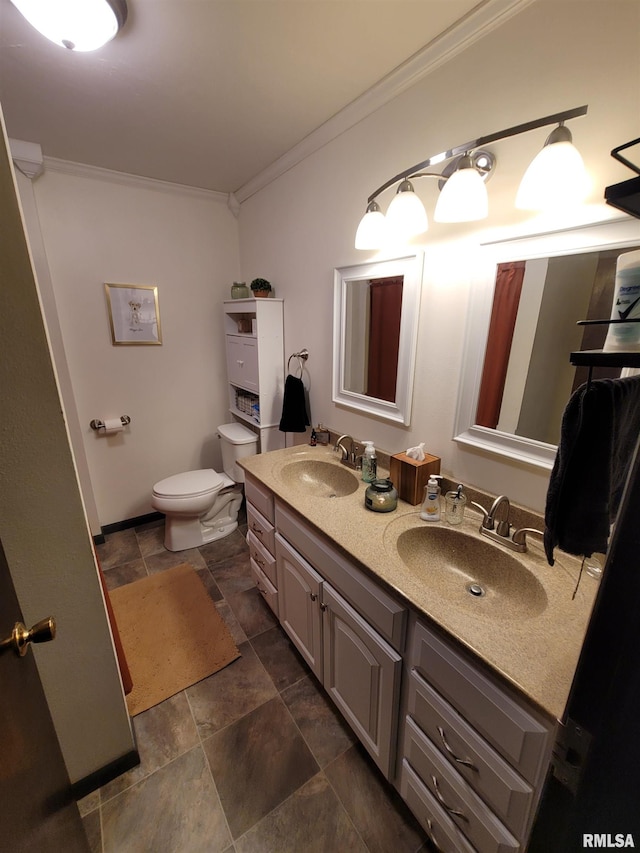 full bathroom featuring double vanity, ornamental molding, a sink, and toilet
