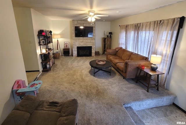 carpeted living area with baseboards, a fireplace, and ceiling fan