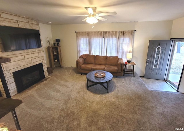 living room featuring ceiling fan, carpet floors, and a fireplace