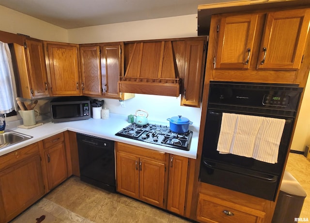 kitchen with light countertops, brown cabinets, black appliances, custom range hood, and a warming drawer