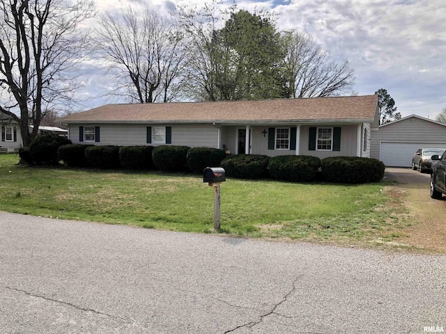 ranch-style home with driveway, a front yard, an outdoor structure, and a garage