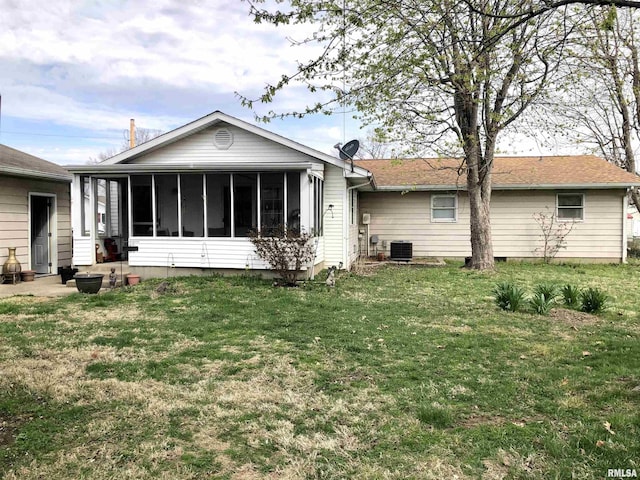 back of property with a lawn, a sunroom, central AC unit, and crawl space