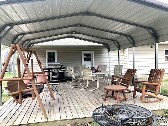 wooden deck featuring grilling area, outdoor dining area, and a detached carport