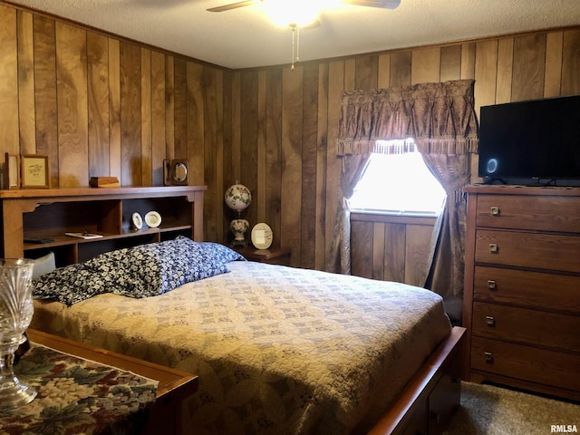 bedroom featuring wood walls and ceiling fan