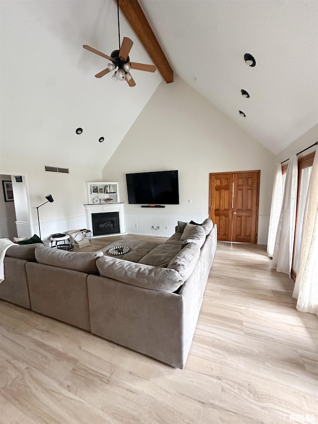 701 Rachael Ct, Carterville, IL 62918 - living room featuring beamed ceiling, light wood finished floors, visible vents, a ceiling fan, and a fireplace