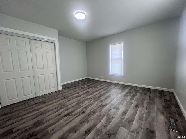421 N 18th St, Herrin, IL 62948 - unfurnished bedroom featuring a closet, dark wood-type flooring, baseboards, and visible vents