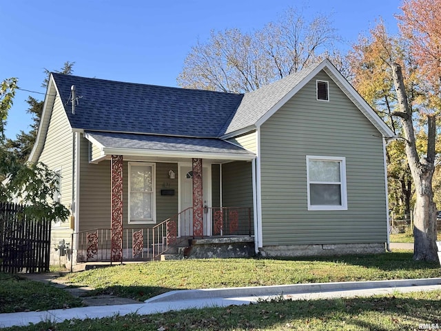 421 N 18th St, Herrin, IL 62948 - view of front facade featuring a front lawn, a shingled roof, covered porch, and fence