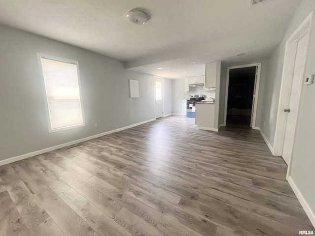 421 N 18th St, Herrin, IL 62948 - unfurnished living room featuring dark wood-type flooring and baseboards