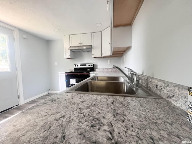 421 N 18th St, Herrin, IL 62948 - kitchen featuring a sink, white cabinetry, stainless steel range with electric stovetop, under cabinet range hood, and baseboards