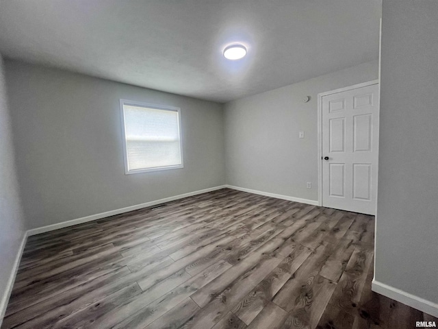 421 N 18th St, Herrin, IL 62948 - empty room featuring dark wood-type flooring and baseboards