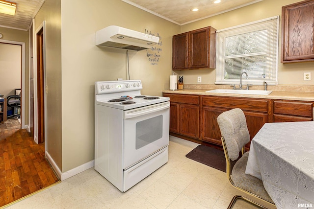 804 N Almond St, Carbondale, IL 62902 - kitchen featuring light countertops, under cabinet range hood, white range with electric cooktop, a sink, and light floors
