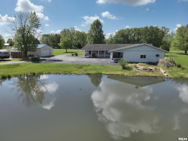 7979 State Route 14th Hwy, Duquoin, IL 62832 - back of property with asphalt driveway, a yard, a detached garage, an outbuilding, and a water view
