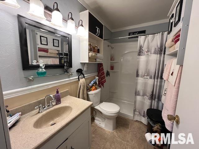 188 W Honeysuckle Dr, Elizabethtown, IL 62931 - bathroom featuring tile patterned floors, crown molding, toilet, vanity, and curtained shower